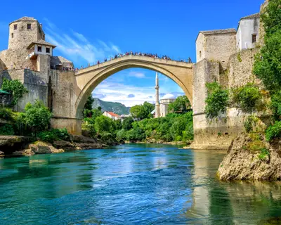 Historical Stari Most (Old Bridge) and Koski Mehmed Mosque in the Old Town Mostar on Neretva River, Bosnia and Herzegovina