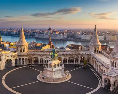 Budapest, Hungary - The famous Fisherman's Bastion at sunrise with statue of King Stephen I and Parliament of Hungary at background