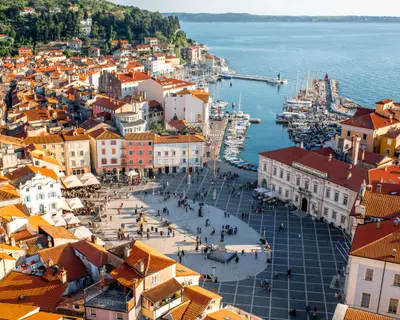 Beautiful aerial view on Piran town with Tartini main square, ancient buildings with red roofs and Adriatic sea in southwestern Slovenia