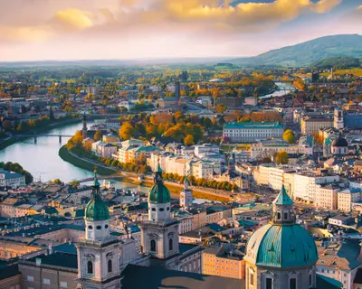 Beautiful of Aerial panoramic view in a Autumn season at a historic city of Salzburg with Salzach river in beautiful golden evening light sky and colorful of autumn at sunset, Salzburger Land, Austria