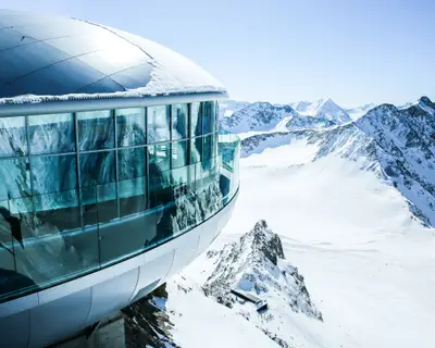 Cafe 3440 on the Pitztal Glacier. Austrias highest coffee house at mountain peak in Tirol, Pitztal Glacier and panoramic view of snow covered mountain range. Alps. Austria. Pitztaler Gletscher. Wildspitzbahn