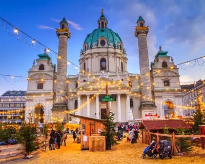 Festive cityscape - view of the Christmas Market on Karlsplatz (Charles' Square) and the Karlskirche (St. Charles Church) in the city of Vienna, Austria, 3 December, 2019