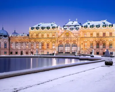 Vienna, Austria. Upper Belvedere snowy winter night reflection, Wien austrian travel background.