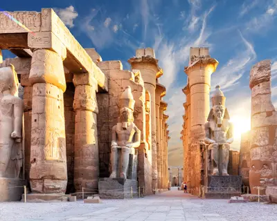 Columns and statues of the Luxor temple main entrance, first pylon, Egypt.
