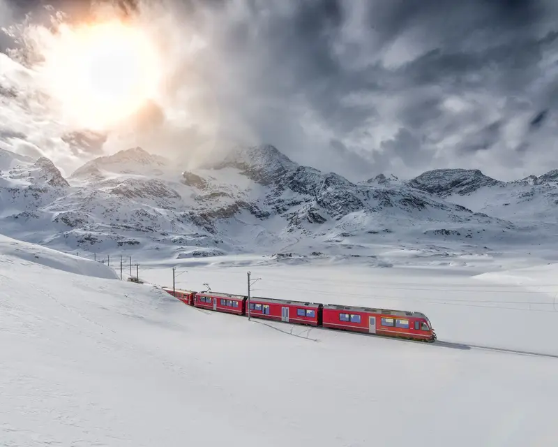 Swiss mountain train Bernina Express crossed through the high mountain snow