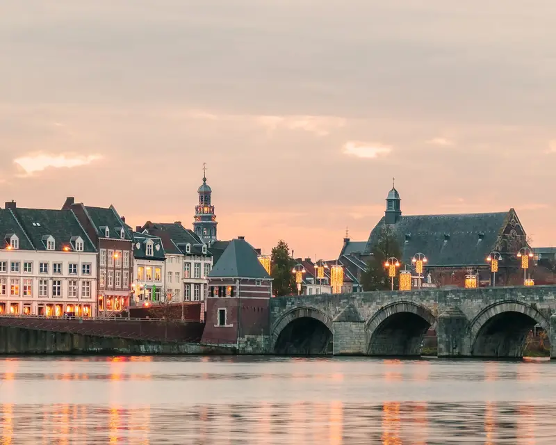 Panoramic view at the famous Dutch Sint Servaas bridge with lights in the city center of Maastricht